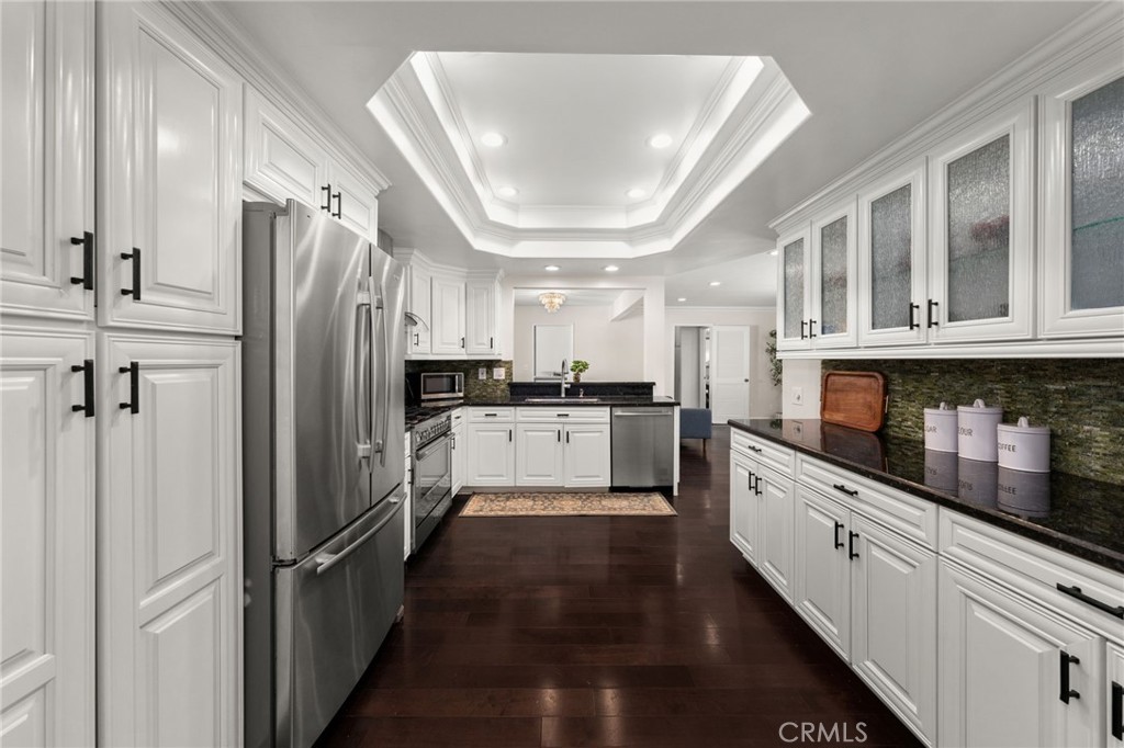 1274 Muirfield Road Riverside, CA 92506 - Photo 10 of 48 a kitchen with stainless steel appliances a refrigerator sink and cabinets