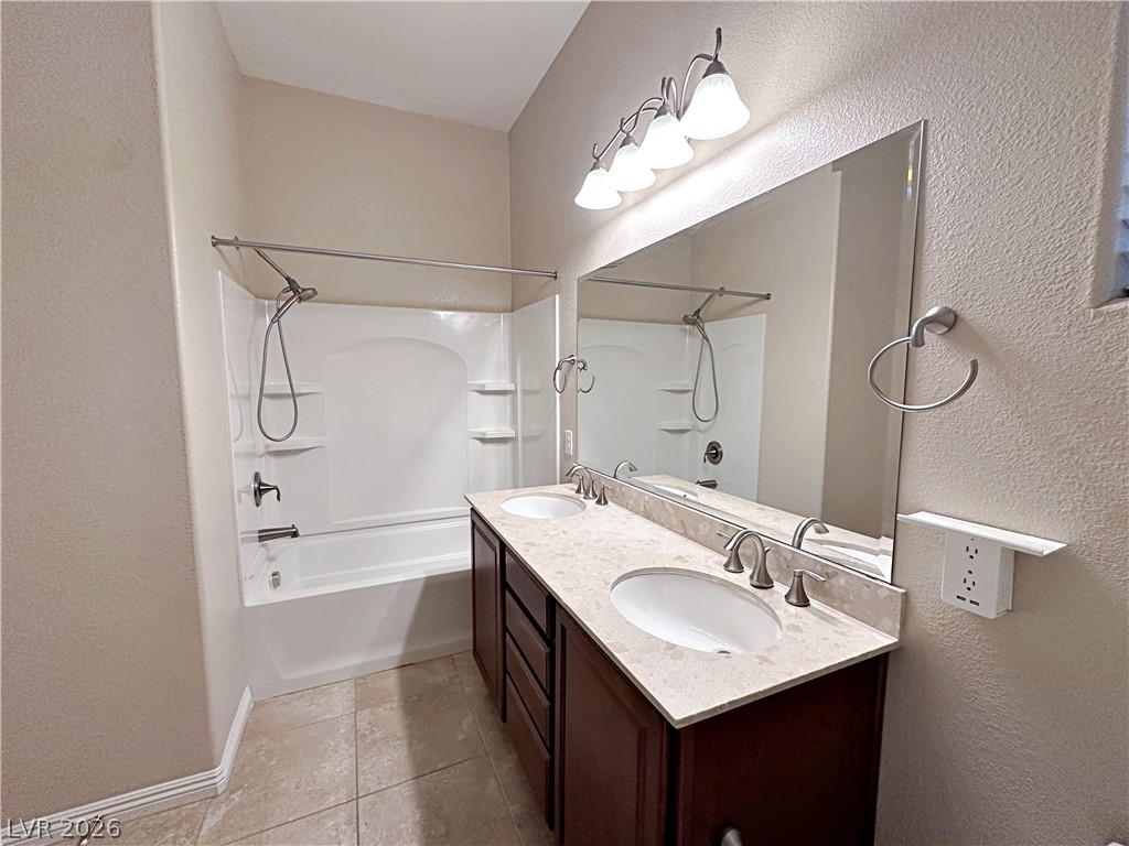 71 Newton Ridge Way Las Vegas, NV 89183 - Photo 22 of 40 Functional primary bath featuring a dual vanity and combined tub and shower for everyday ease.