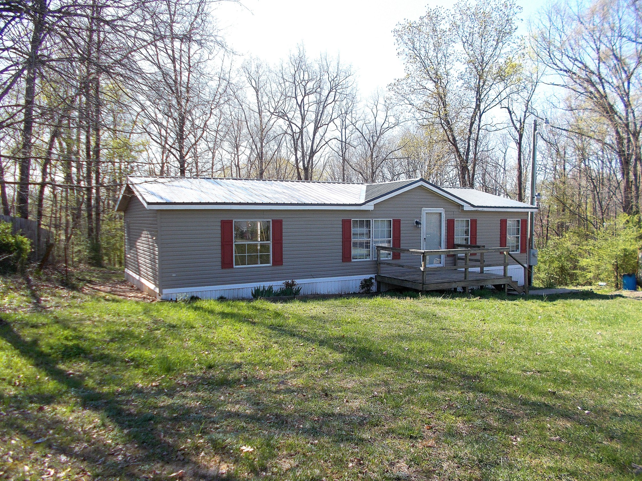 a front view of a house with yard porch and green space