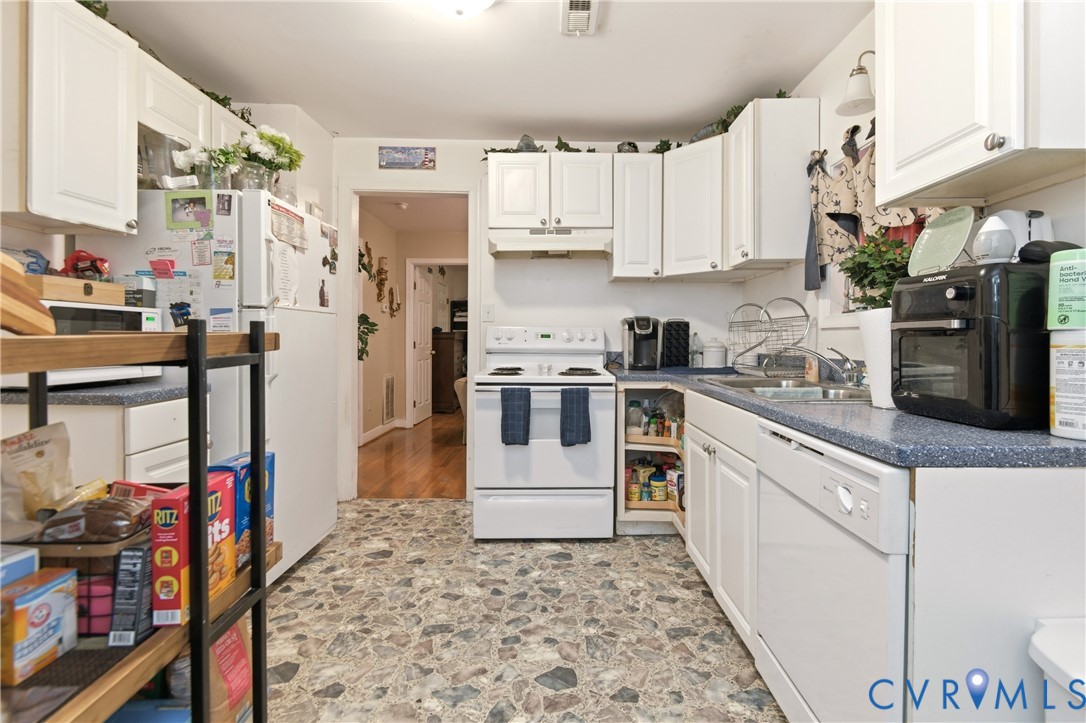 1311 Williamsburg Road Richmond, VA 23231 - Photo 16 of 32 a kitchen with stainless steel appliances granite countertop a refrigerator a stove and a sink