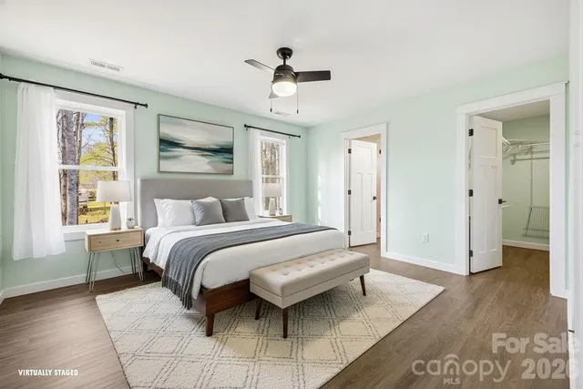 a spacious bedroom with a bed and a chandelier