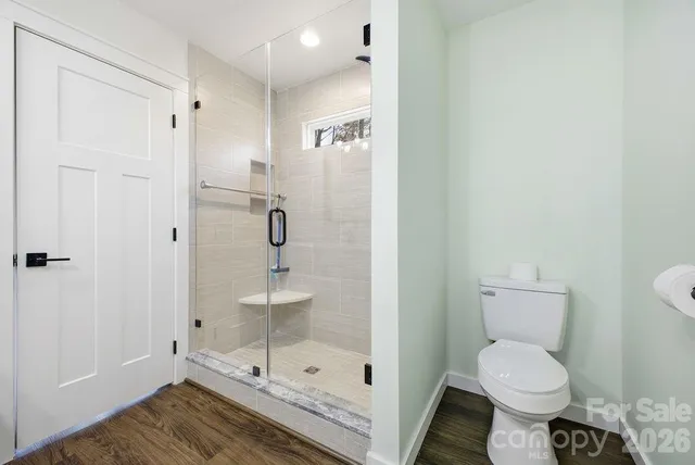 a bathroom with a toilet sink and shower