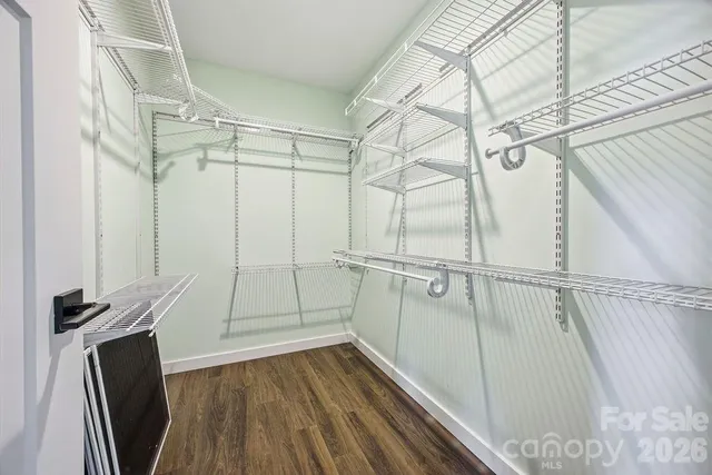 a view of walk in closet with empty racks