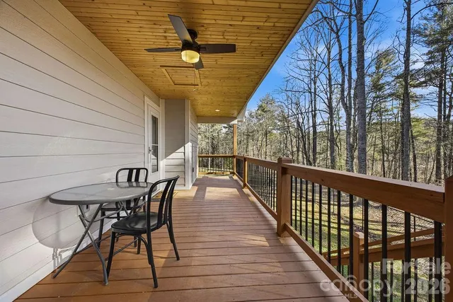 a view of balcony with wooden floor and outdoor seating