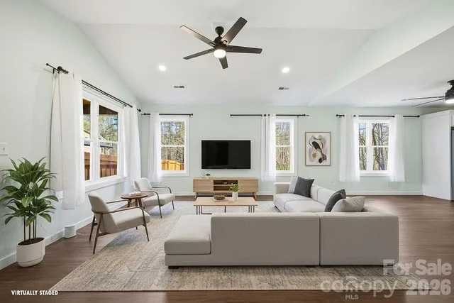 a living room with furniture and a flat screen tv