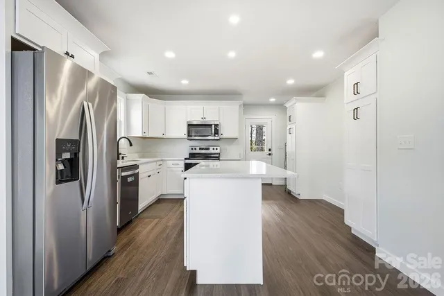 a kitchen with a refrigerator a sink and dishwasher