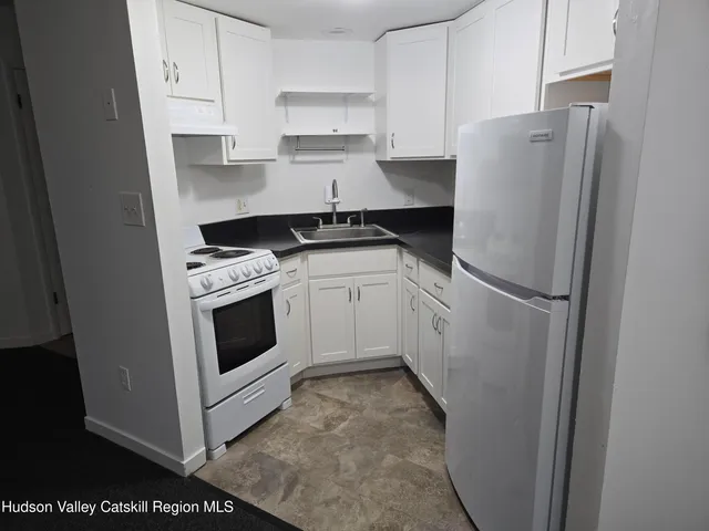 a kitchen with stainless steel appliances white cabinets and white appliances