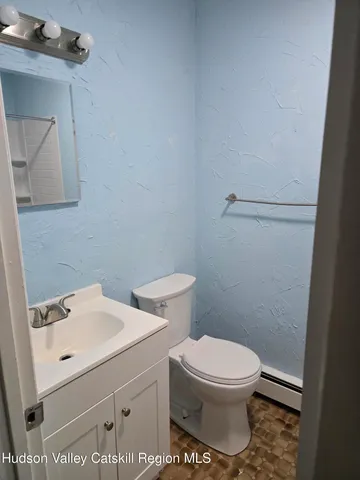 a white toilet sitting next to a bathroom sink