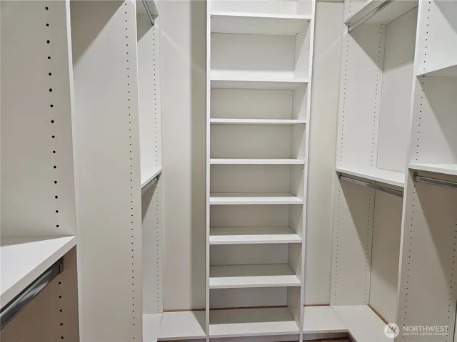 a view of walk in closet with empty racks