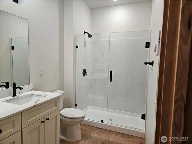 a bathroom with a sink toilet and shower