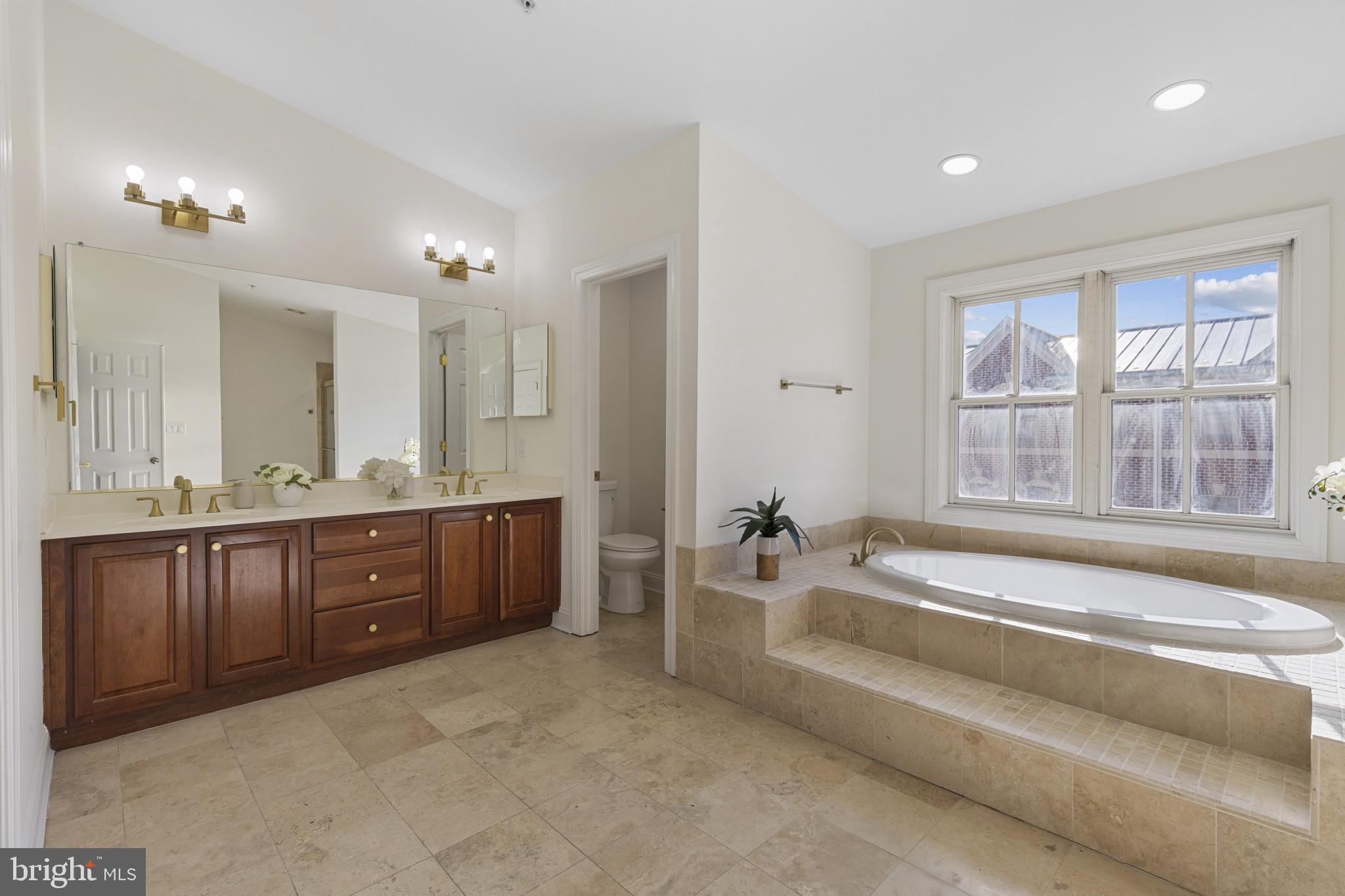 1256 Dockside Circle Baltimore, MD 21224 - Photo 15 of 41 a spacious bathroom with a tub sink and mirror