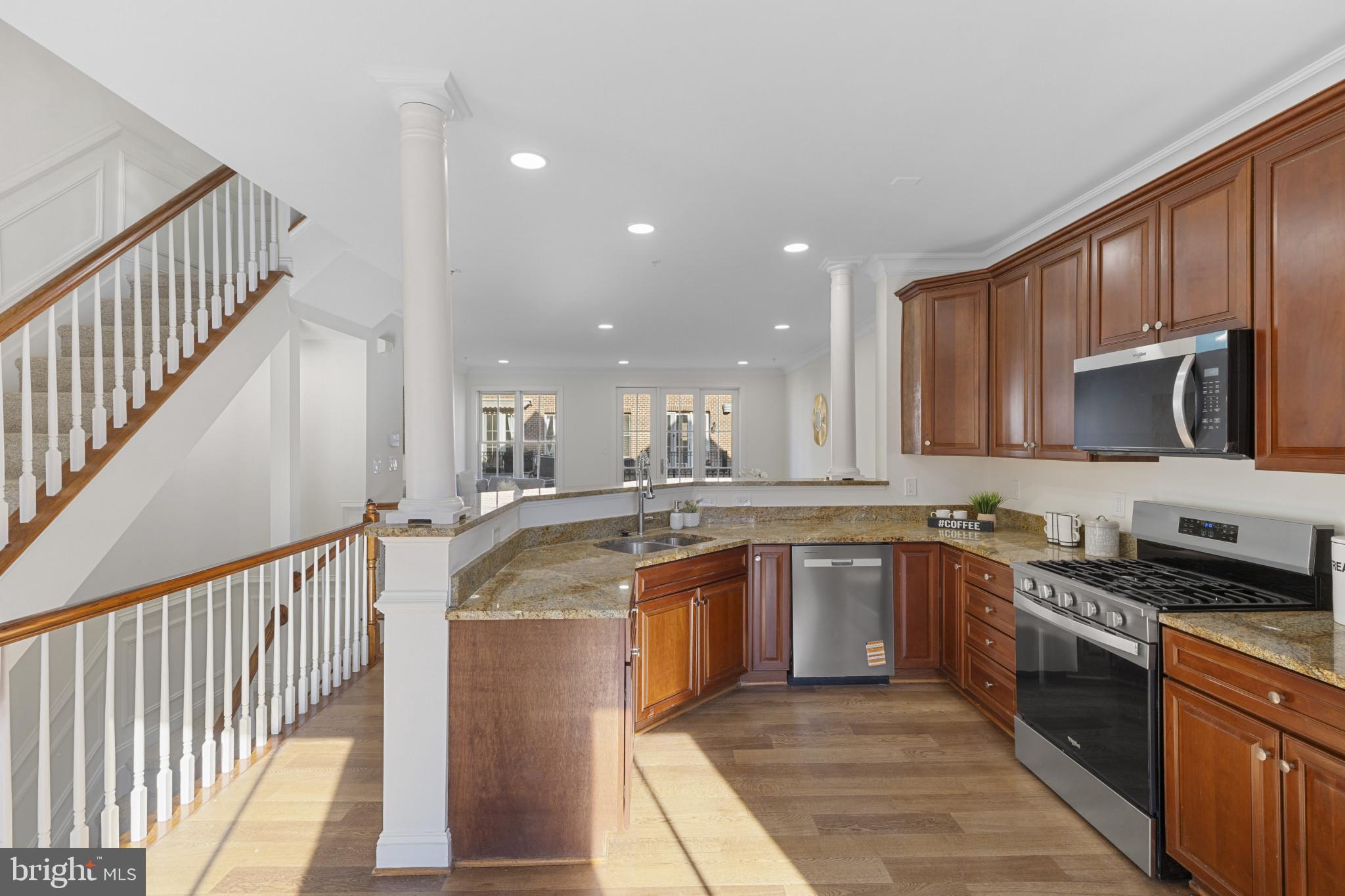 1256 Dockside Circle Baltimore, MD 21224 - Photo 2 of 41 a large kitchen with stainless steel appliances granite countertop a sink and cabinets