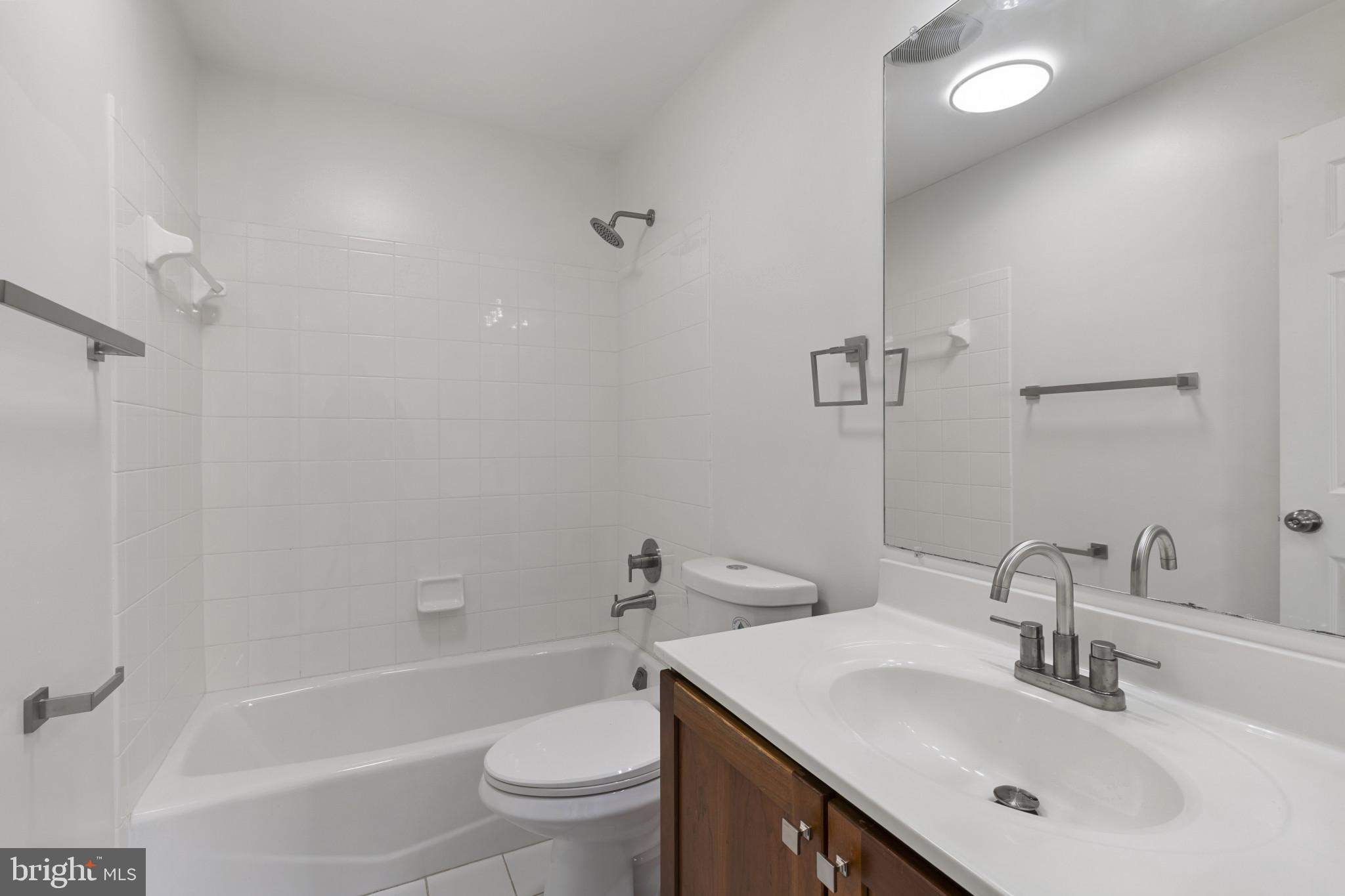 1256 Dockside Circle Baltimore, MD 21224 - Photo 10 of 41 a bathroom with a sink toilet vanity and shower