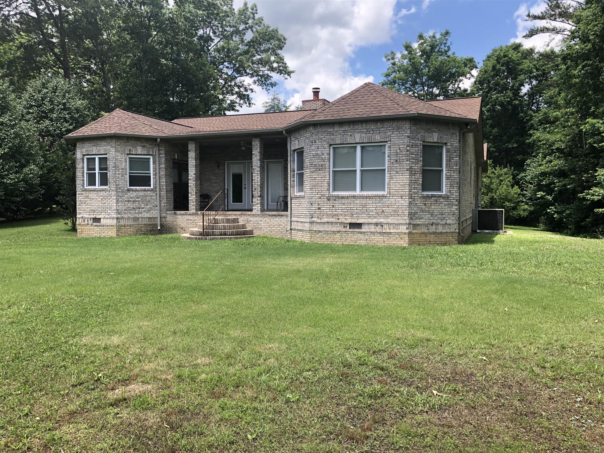 374 Eagle Lake Road Coalmont, TN 37313 - Photo 11 of 28 a front view of a house with a garden and porch