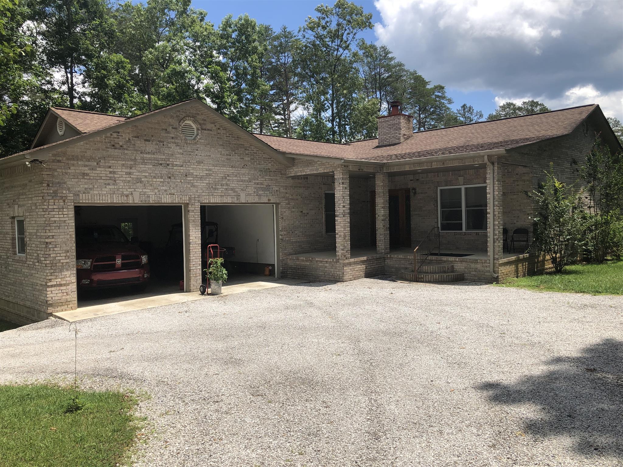 374 Eagle Lake Road Coalmont, TN 37313 - Photo 5 of 28 a front view of a house with a yard and garage
