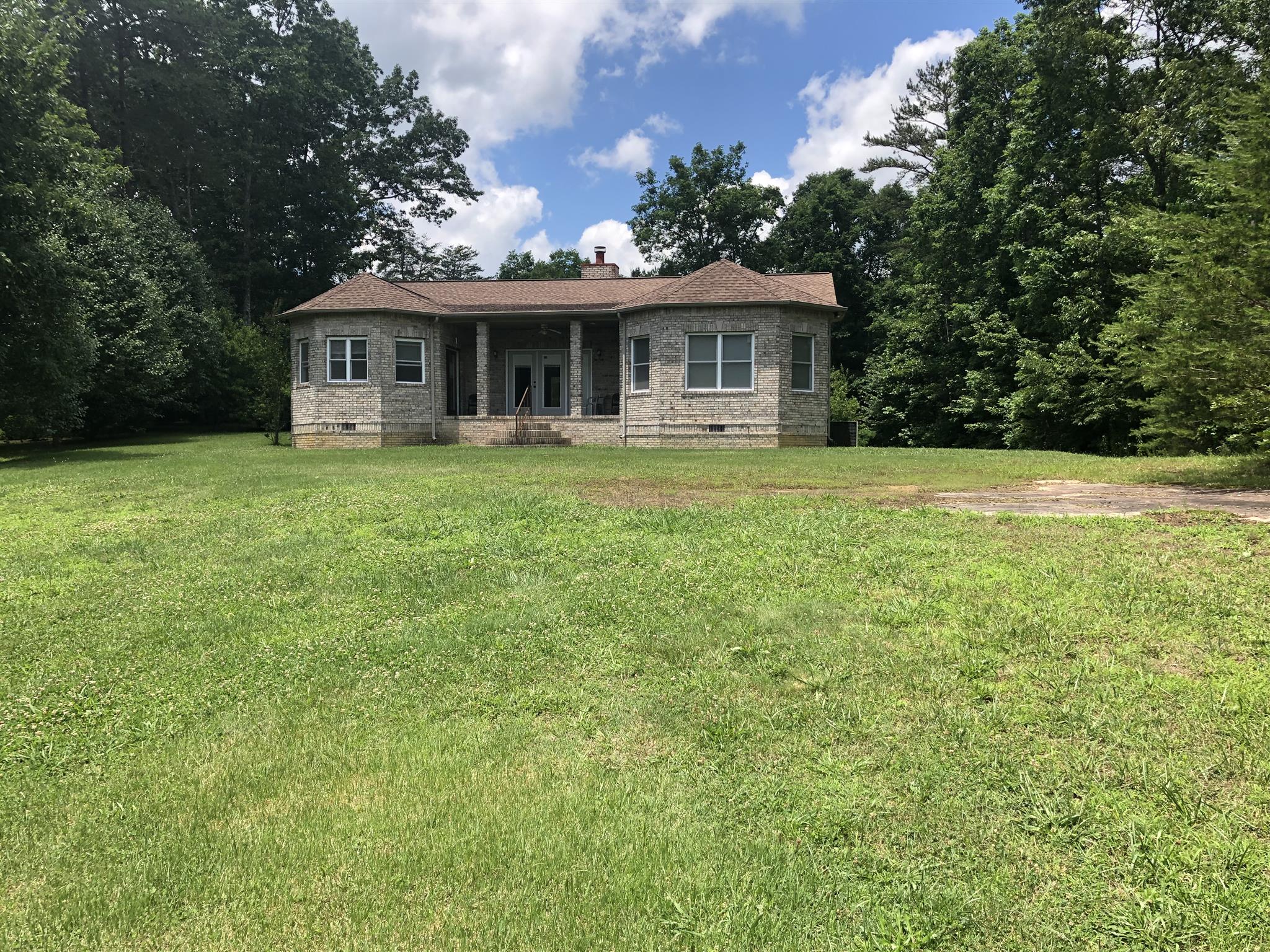 374 Eagle Lake Road Coalmont, TN 37313 - Photo 10 of 28 a front view of a house with a garden