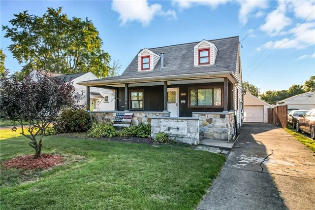 a front view of a house with garden