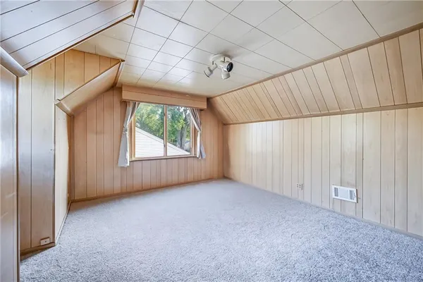 an empty room with closet and a hallway