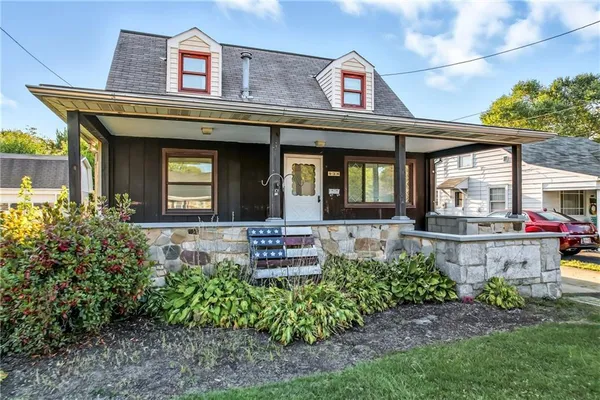 front view of a house with a garden
