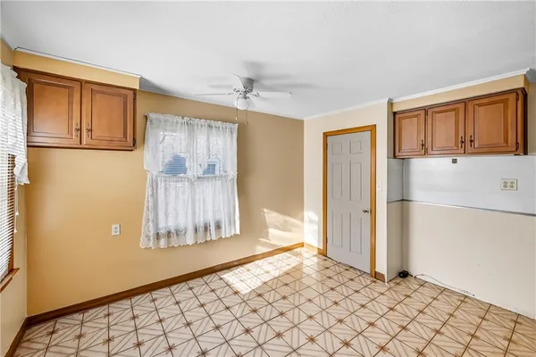 a view of empty room with wooden floor and cabinet