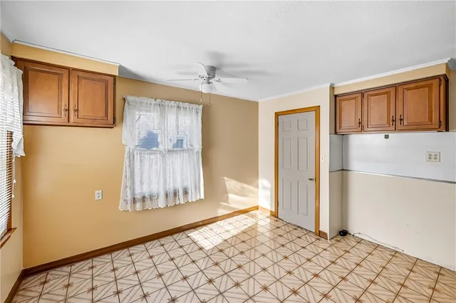 a view of empty room with wooden floor and cabinet