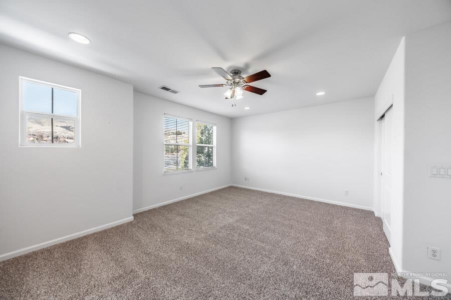 1680 Spicewood Circle Reno, NV 89523 - Photo 23 of 39 an empty room with windows and fan