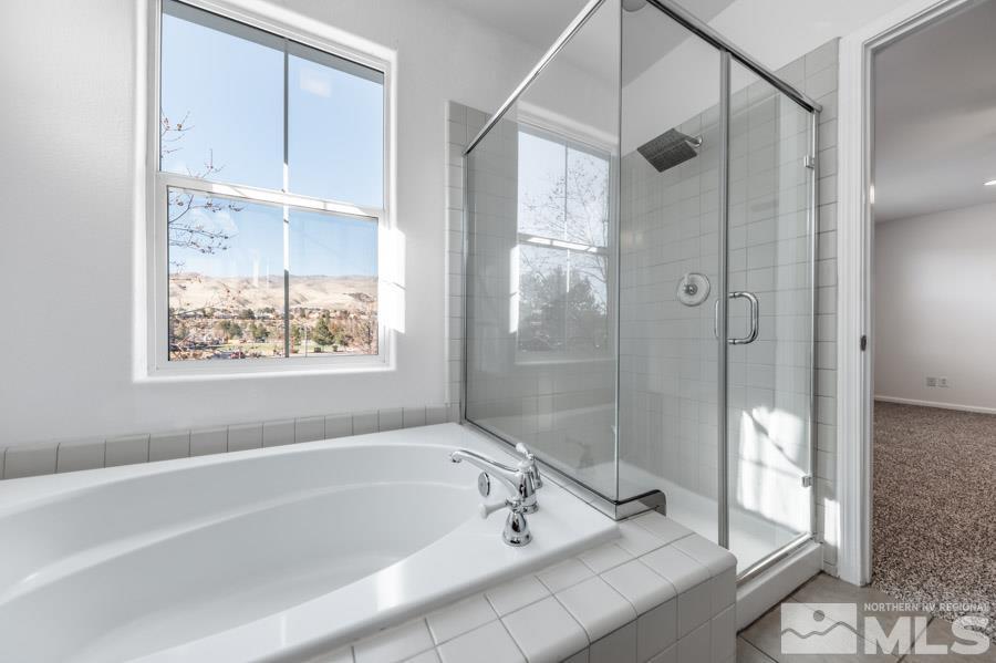 1680 Spicewood Circle Reno, NV 89523 - Photo 27 of 39 a bathroom with a tub and a shower