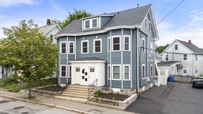 a front view of a house with a garden