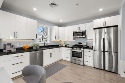 167 Charles Street, Unit 4 Waltham, MA 02453 - Photo 3 of 9 a kitchen with granite countertop a refrigerator stove microwave and sink