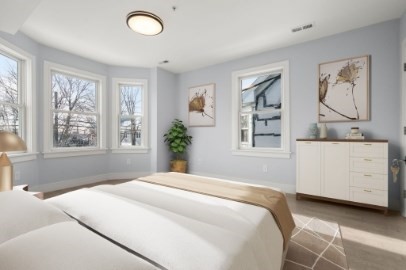 167 Charles Street, Unit 4 Waltham, MA 02453 - Photo 6 of 9 a bedroom with a bed and a window