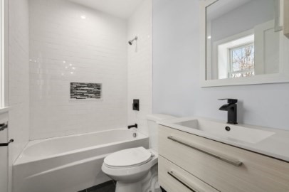 167 Charles Street, Unit 4 Waltham, MA 02453 - Photo 8 of 9 a bathroom with a sink a toilet and shower