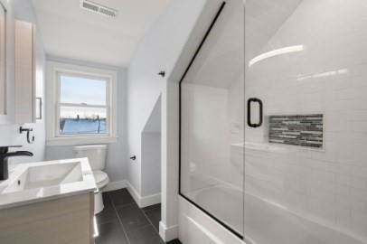 167 Charles Street, Unit 4 Waltham, MA 02453 - Photo 9 of 9 a bathroom with a sink a toilet and shower