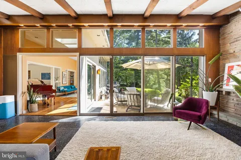 a dining room with furniture and a chandelier