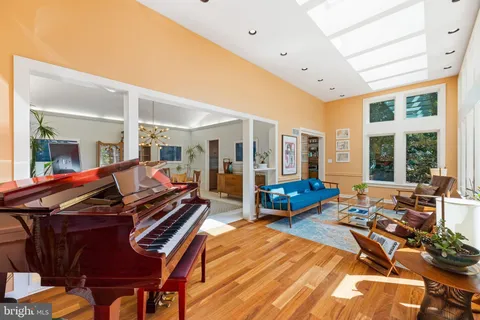 a kitchen with stainless steel appliances kitchen island granite countertop a table chairs and a refrigerator