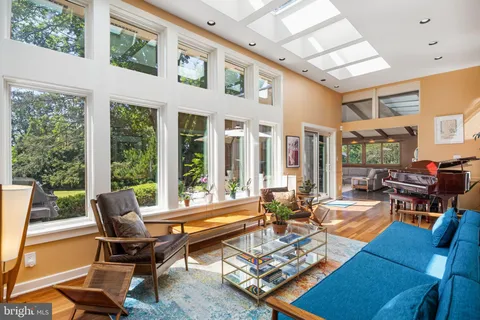 a view of a workspace with furniture and a bookshelf