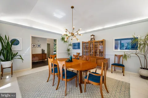 a bedroom with furniture and a large window