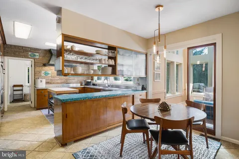 a bathroom with a granite countertop sink mirror and shower