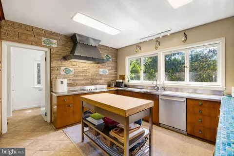 a view of a room with gym equipment and floor to ceiling window