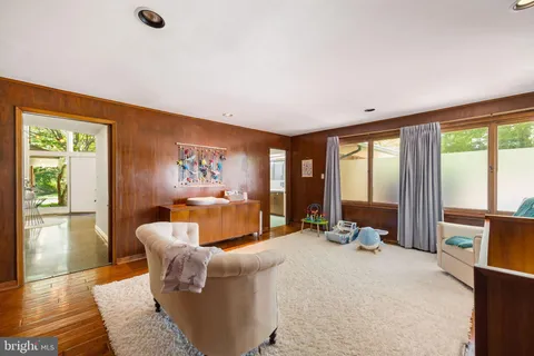 an aerial view of residential house with outdoor space and trees all around