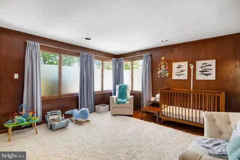 a backyard of a house with a yard and large trees