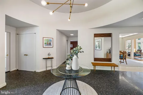 a living room with furniture a fireplace and a floor to ceiling window