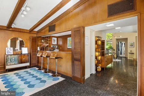 a front view of a house with exposed pipes and a window