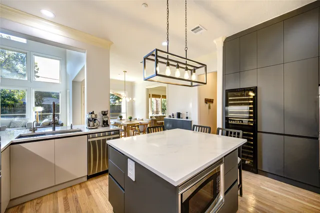 a kitchen with a stove a refrigerator and a sink