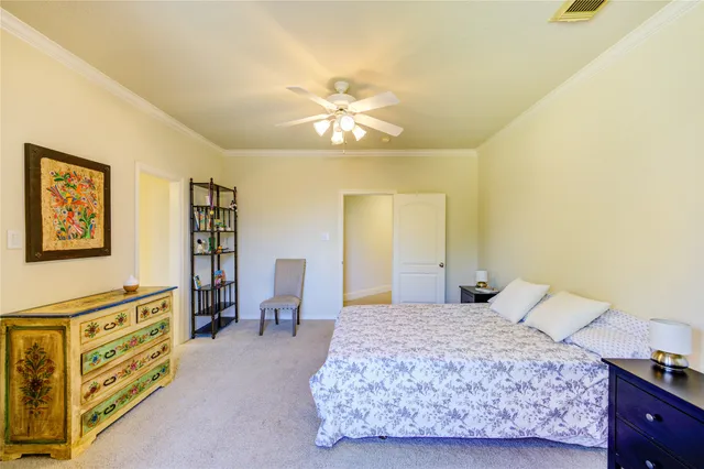 a bedroom with a bed and dresser in it