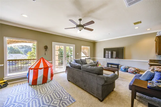 a living room with furniture a rug and a chandelier