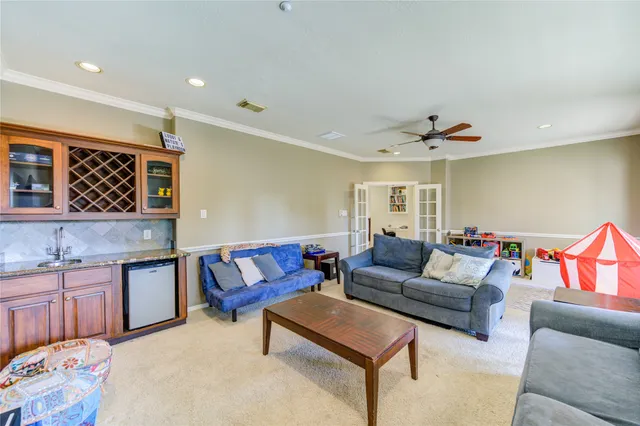 a living room with furniture and kitchen view