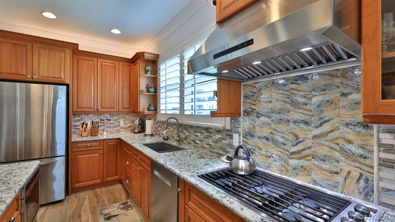 606 Midfield Loop Edgewater, FL 32132 - Photo 14 of 42 a kitchen with stainless steel appliances granite countertop a sink stove and refrigerator