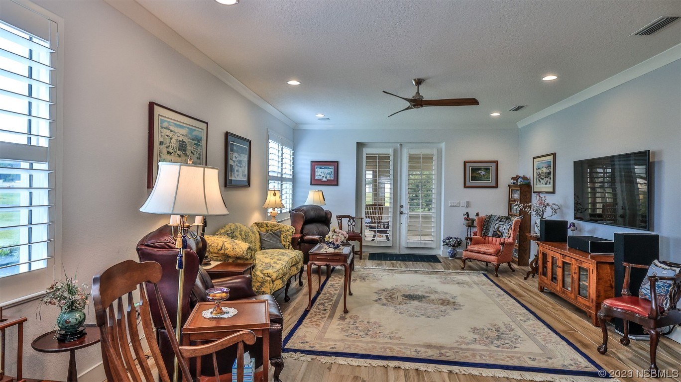 606 Midfield Loop Edgewater, FL 32132 - Photo 18 of 42 a living room with furniture a window and a flat screen tv