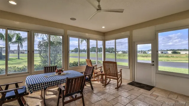 a view of a dining room with furniture window and outside view