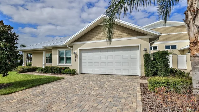 a front view of house with yard and trees